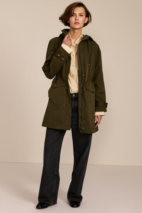 Women's raincoat with drawstring waist and hood.