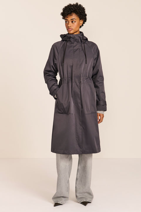 Women's water-repellent hooded raincoat with adjustable drawcord waist and patch pockets