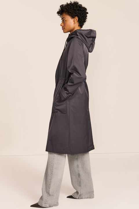 Women's water-repellent hooded raincoat with adjustable drawcord waist and patch pockets