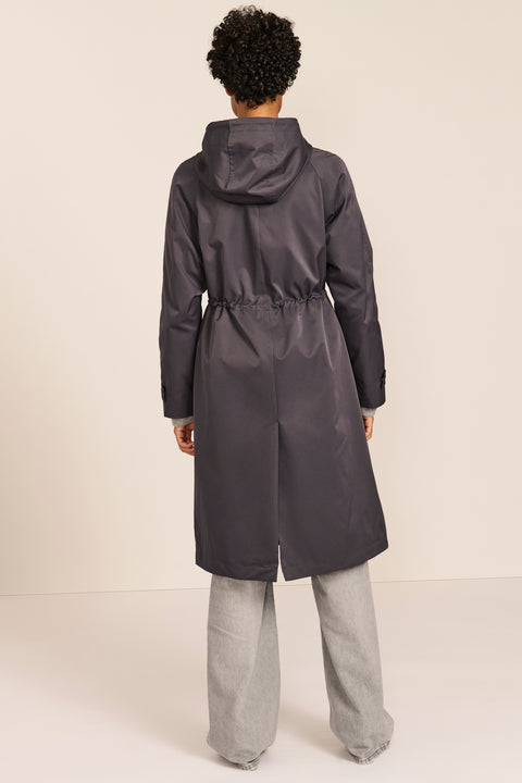 Women's water-repellent hooded raincoat with adjustable drawcord waist and patch pockets