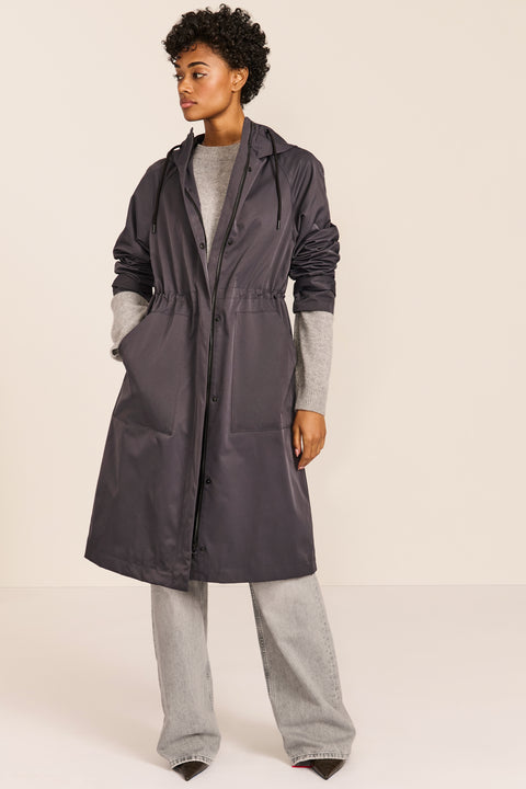 Women's water-repellent hooded raincoat with adjustable drawcord waist and patch pockets
