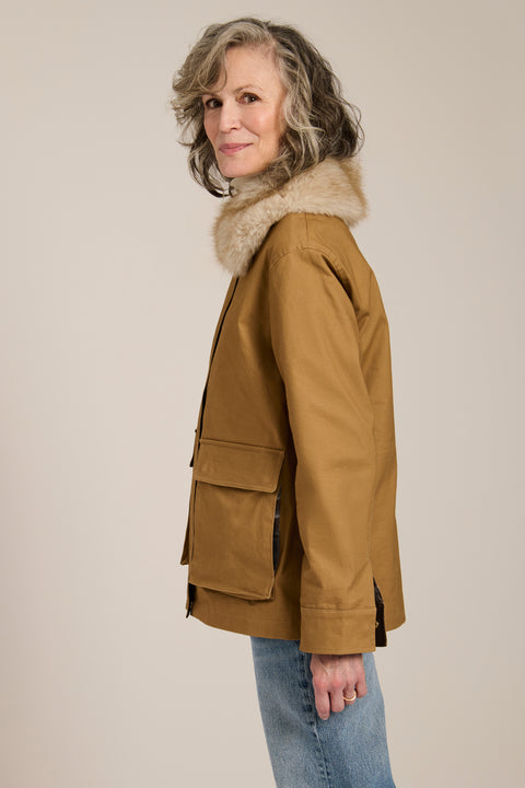 Utility jacket with removable faux fur collar, drawstring waist, oversized flap pockets and hidden zip closure.