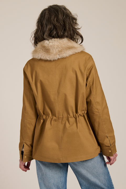 Utility jacket with removable faux fur collar, drawstring waist, oversized flap pockets and hidden zip closure.