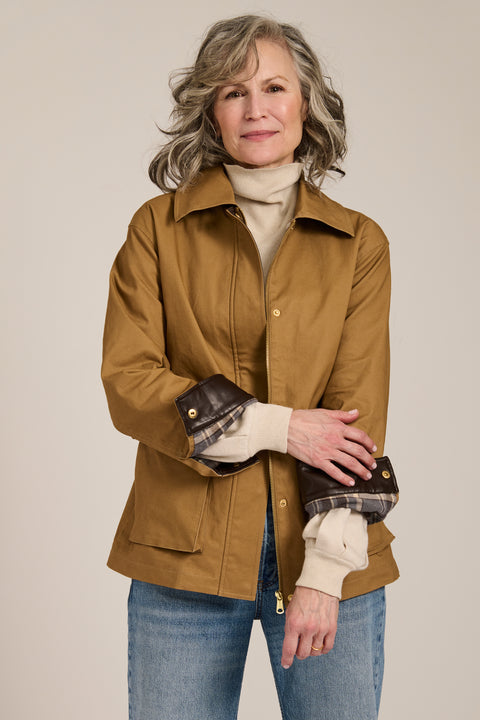 Utility jacket with removable faux fur collar, drawstring waist, oversized flap pockets and hidden zip closure.