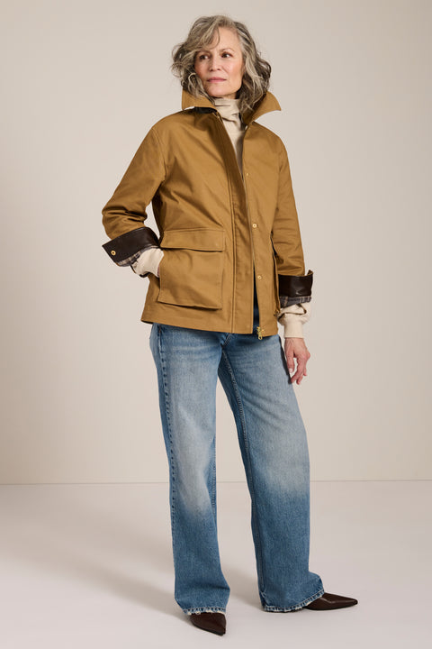Utility jacket with removable faux fur collar, drawstring waist, oversized flap pockets and hidden zip closure.