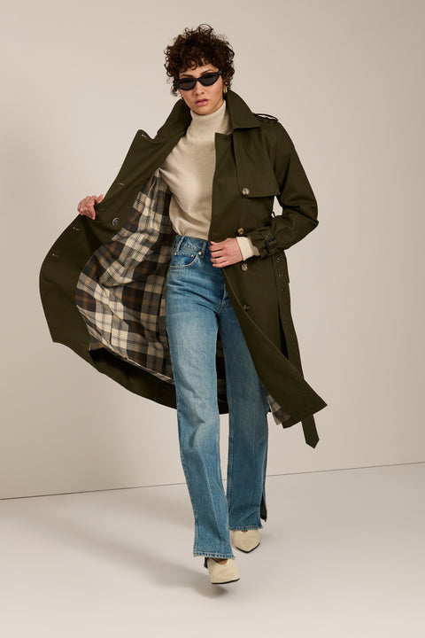 Women's belted trench coat with double-breasted front and water-repellent fabric.