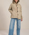 Women's barn raincoat with corduroy collar, plaid lining, and water-repellent finish.