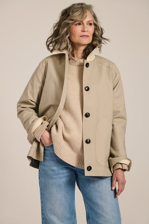Women's barn raincoat with corduroy collar, plaid lining, and water-repellent finish.