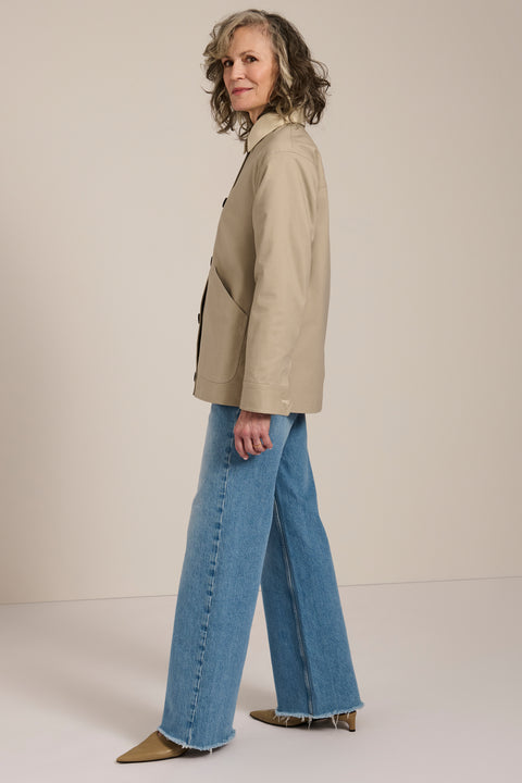 Women's barn raincoat with corduroy collar, plaid lining, and water-repellent finish.