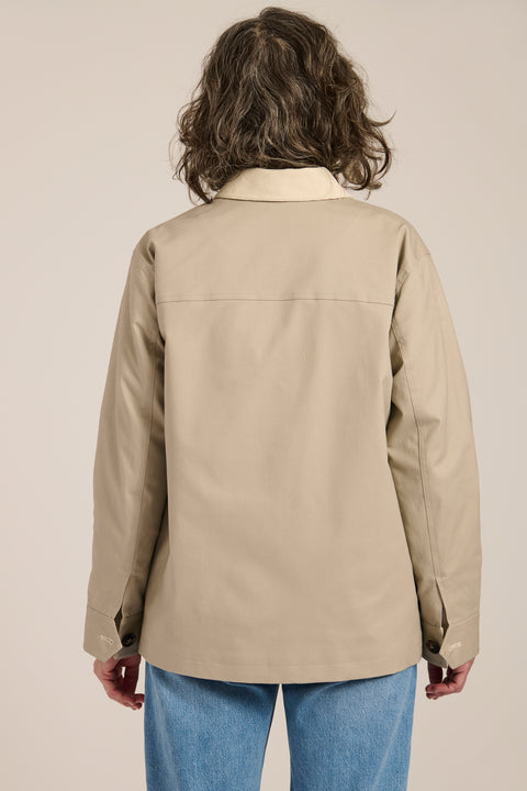 Women's barn raincoat with corduroy collar, plaid lining, and water-repellent finish.