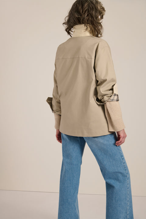 Women's barn raincoat with corduroy collar, plaid lining, and water-repellent finish.