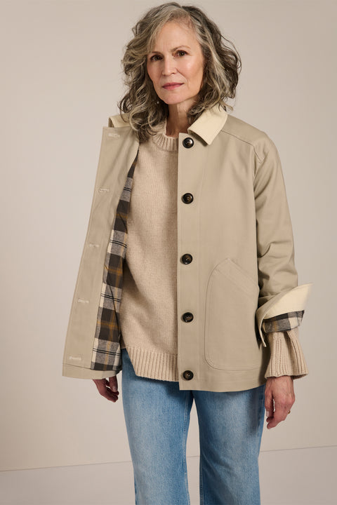 Women's barn raincoat with corduroy collar, plaid lining, and water-repellent finish.