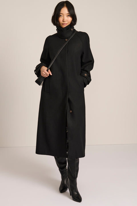 women's long wool coat in black with a sculptural convertible collar, long relaxed silhouette and button-tab cuffs.