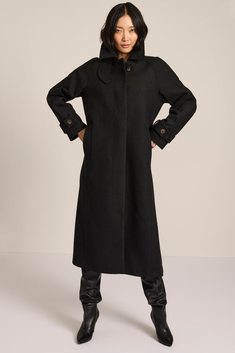 women's long wool coat in black with a sculptural convertible collar, long relaxed silhouette and button-tab cuffs.