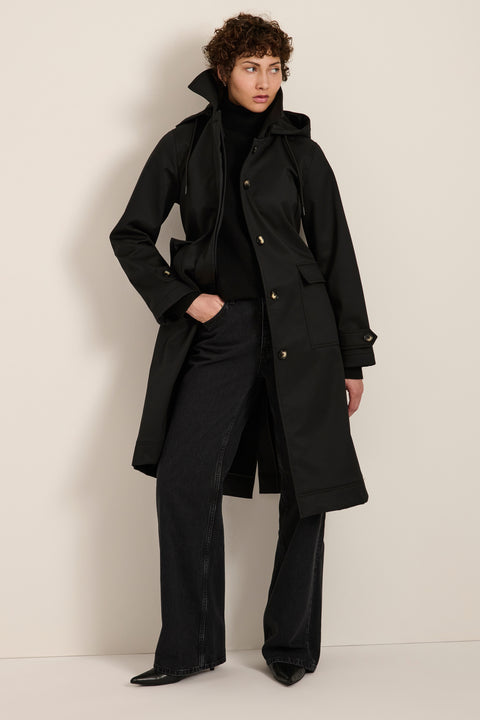 Women's belted raincoat with removable hood and water-repellent finish.