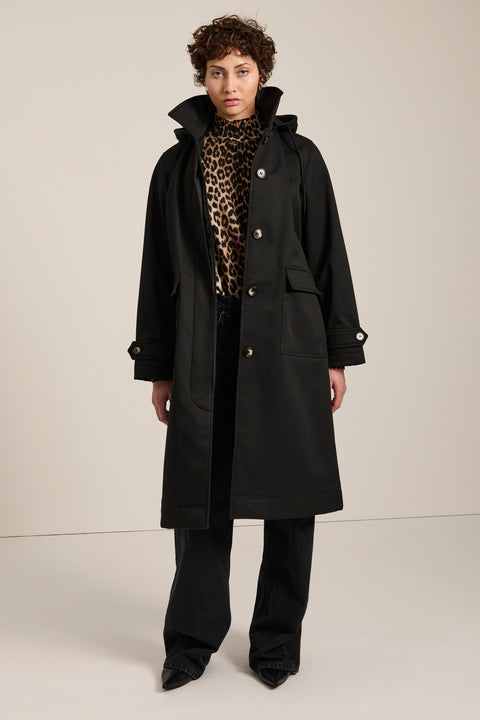 Women's belted raincoat with removable hood and water-repellent finish.
