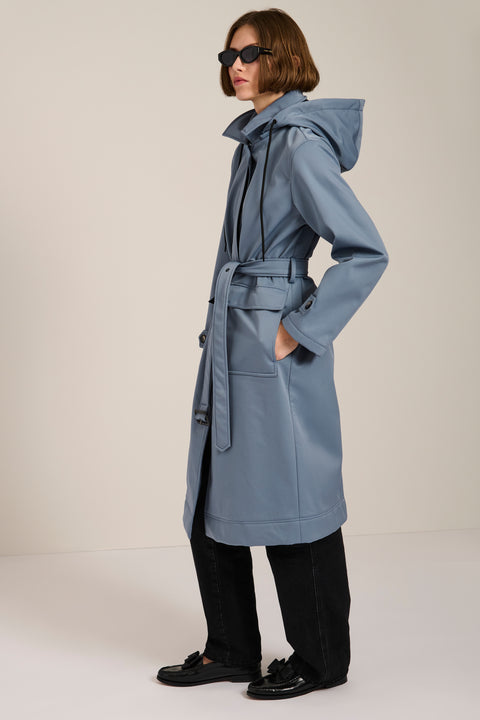 Women's belted raincoat with removable hood and water-repellent finish.
