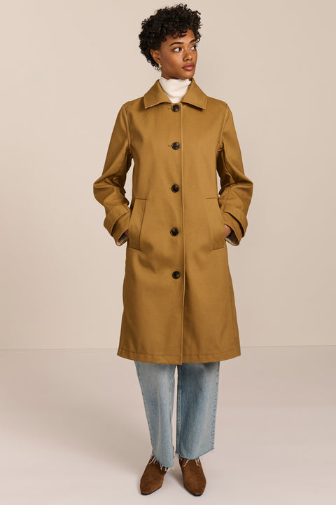 women's plaid-trim raincoat with a hood, stand collar, button-front closure, welt pockets and adjustable cuff tabs.