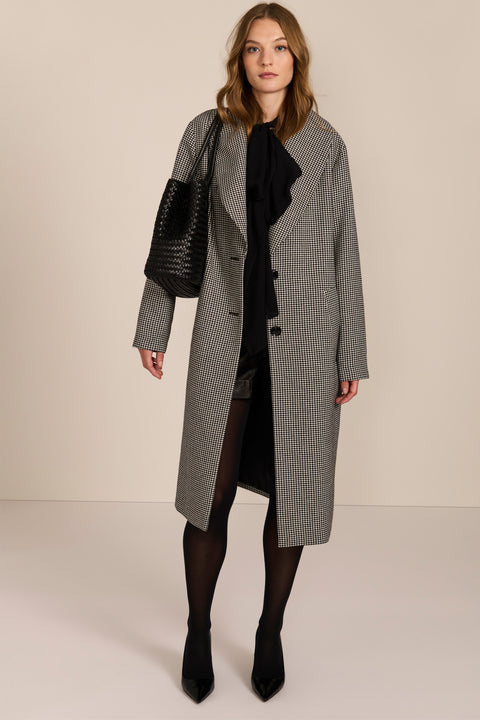 Women's brown houndstooth long coat with oversized notched collar, two-button closure and welt pockets.