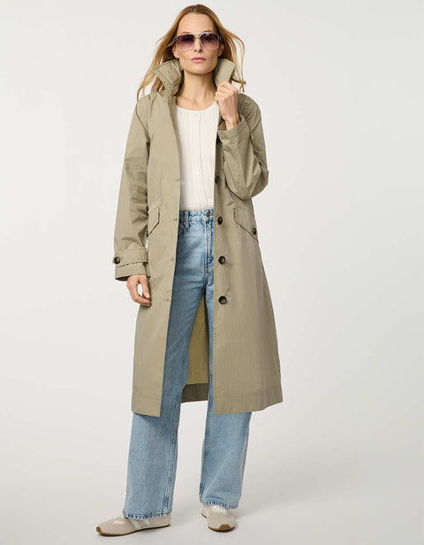 Women’s lightweight utility trench coat with belted waist, flap pockets, and roll-away hood tucked into the collar.
