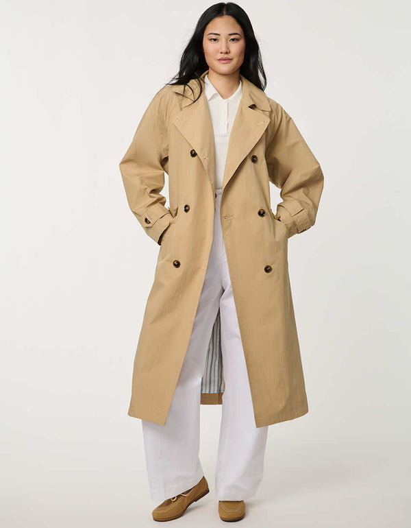 Women’s double-breasted trench coat with belted waist, cuff tabs, and striped interior lining.