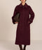 Women's long wool coat featuring a sculptural stand collar, concealed front closure, patch pockets, and button-tab cuffs.