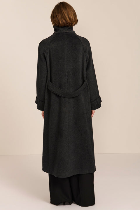 Women's long wool coat featuring a sculptural stand collar, concealed front closure, patch pockets, and button-tab cuffs.