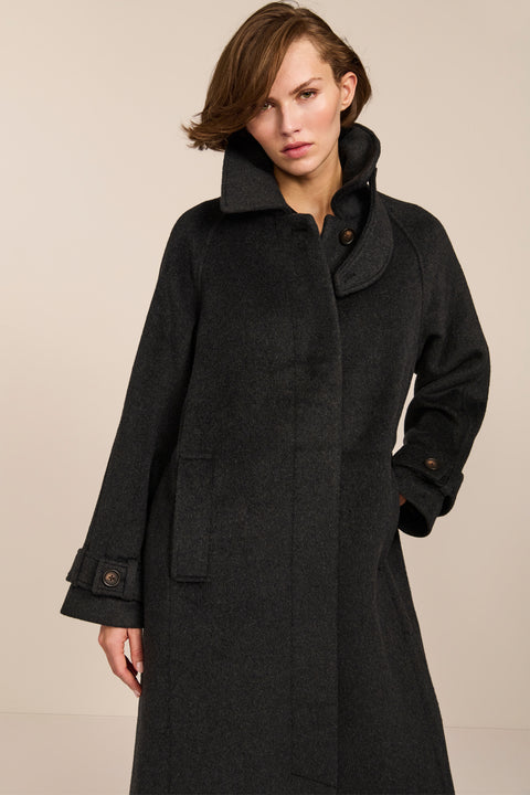 Women's long wool coat featuring a sculptural stand collar, concealed front closure, patch pockets, and button-tab cuffs.