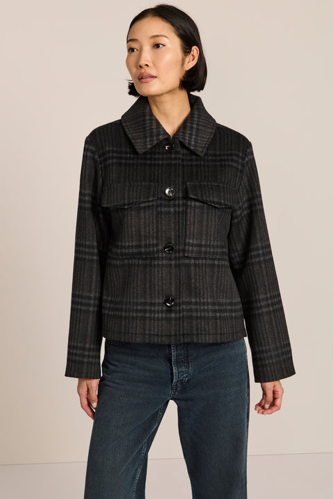 women's cropped plaid wool jacket featuring a point collar, button-front closure, and oversized flap pockets.