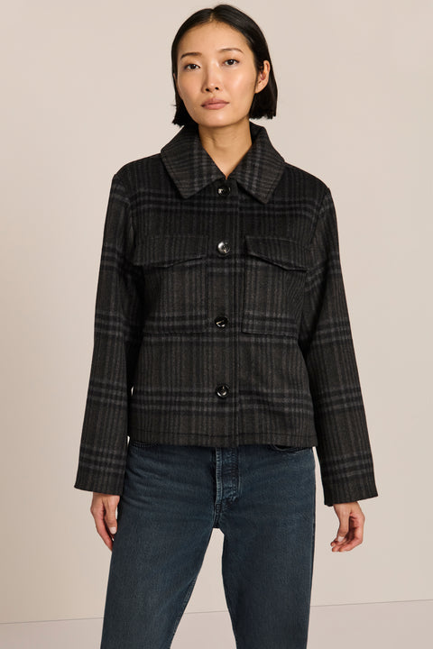 women's cropped plaid wool jacket featuring a point collar, button-front closure, and oversized flap pockets.