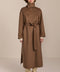 Women's long belted wool coat featuring a high stand collar, asymmetric button closure, wide cuffs and side slits.