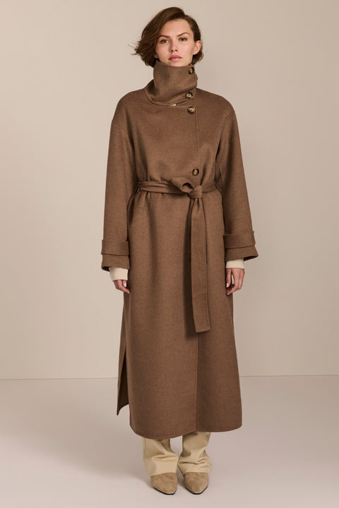 Women's long belted wool coat featuring a high stand collar, asymmetric button closure, wide cuffs and side slits.