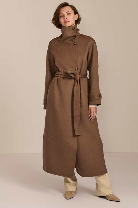 Women's long belted wool coat featuring a high stand collar, asymmetric button closure, wide cuffs and side slits.