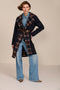 women's double-breasted wool coat with an oversized plaid notched collar, contrasting plaid interior and side pockets.