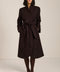 Belted bouclé wrap coat with rounded shawl collar, textured fabric and modern wrap silhouette.