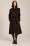 Belted bouclé wrap coat with rounded shawl collar, textured fabric and modern wrap silhouette.