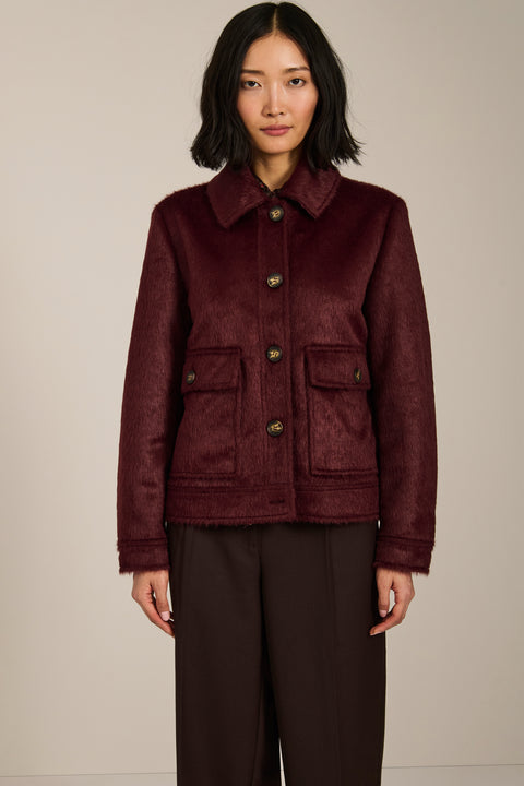 Women's faux calf hair jacket with utility pockets and button-front closure.