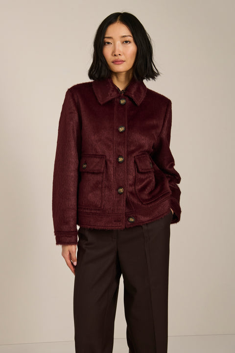 Women's faux calf hair jacket with utility pockets and button-front closure.