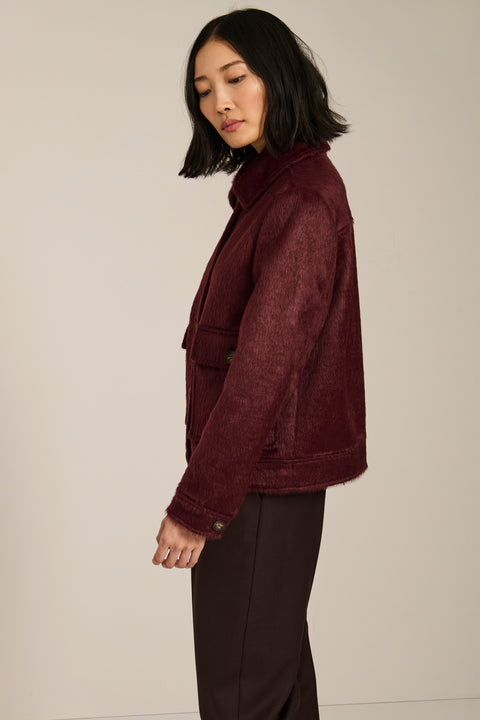 Women's faux calf hair jacket with utility pockets and button-front closure.