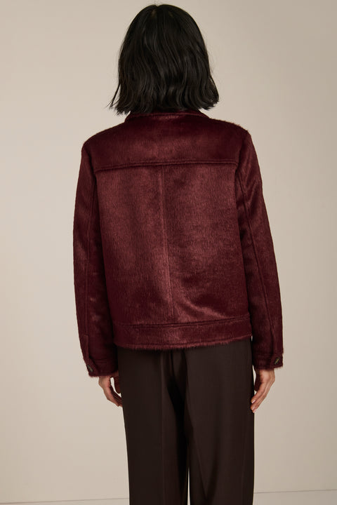 Women's faux calf hair jacket with utility pockets and button-front closure.