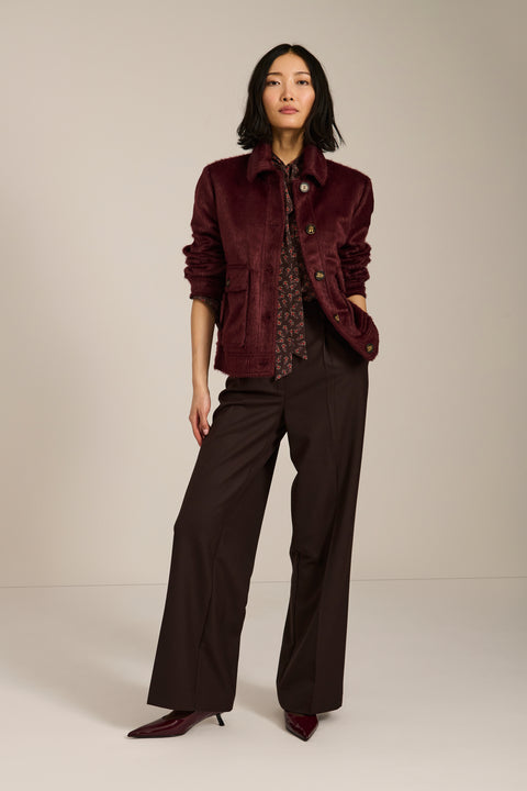 Women's faux calf hair jacket with utility pockets and button-front closure.