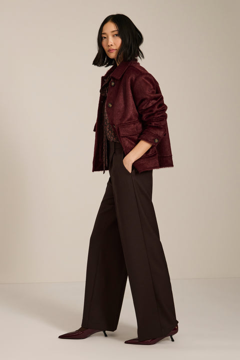 Women's faux calf hair jacket with utility pockets and button-front closure.