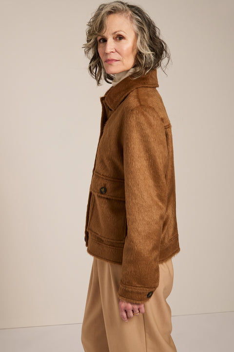 Women's faux calf hair jacket with utility pockets and button-front closure.