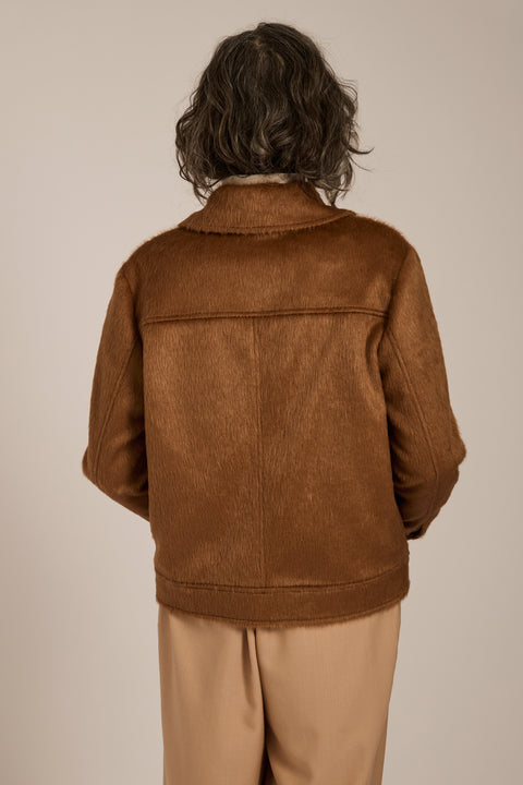 Women's faux calf hair jacket with utility pockets and button-front closure.