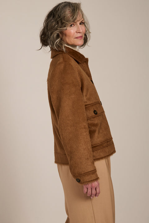 Women's faux calf hair jacket with utility pockets and button-front closure.