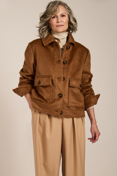 Women's faux calf hair jacket with utility pockets and button-front closure.