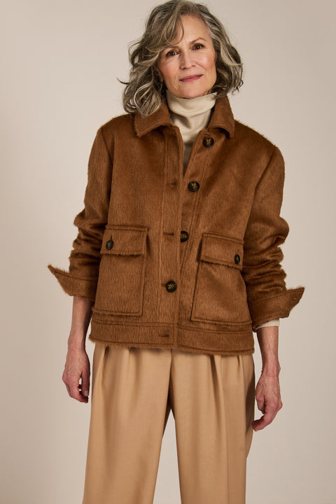 Women's faux calf hair jacket with utility pockets and button-front closure.