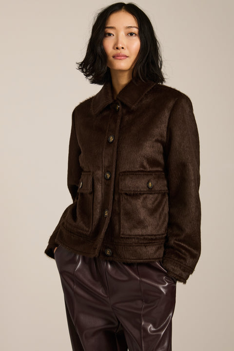 Women's faux calf hair jacket with utility pockets and button-front closure.