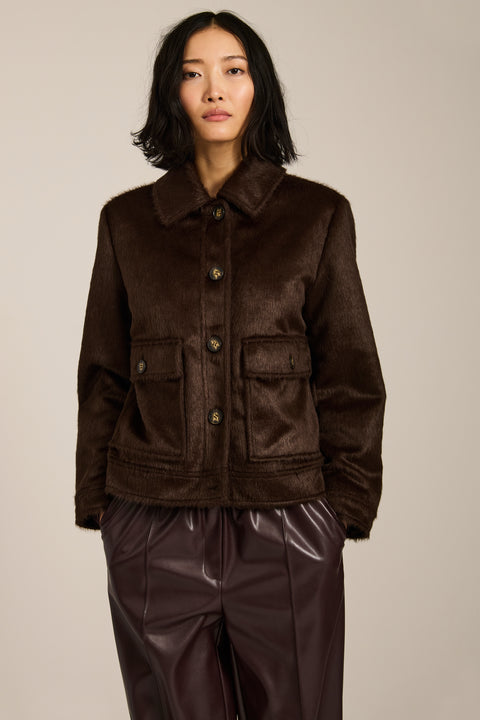 Women's faux calf hair jacket with utility pockets and button-front closure.
