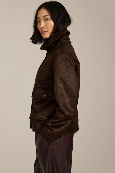 Women's faux calf hair jacket with utility pockets and button-front closure.